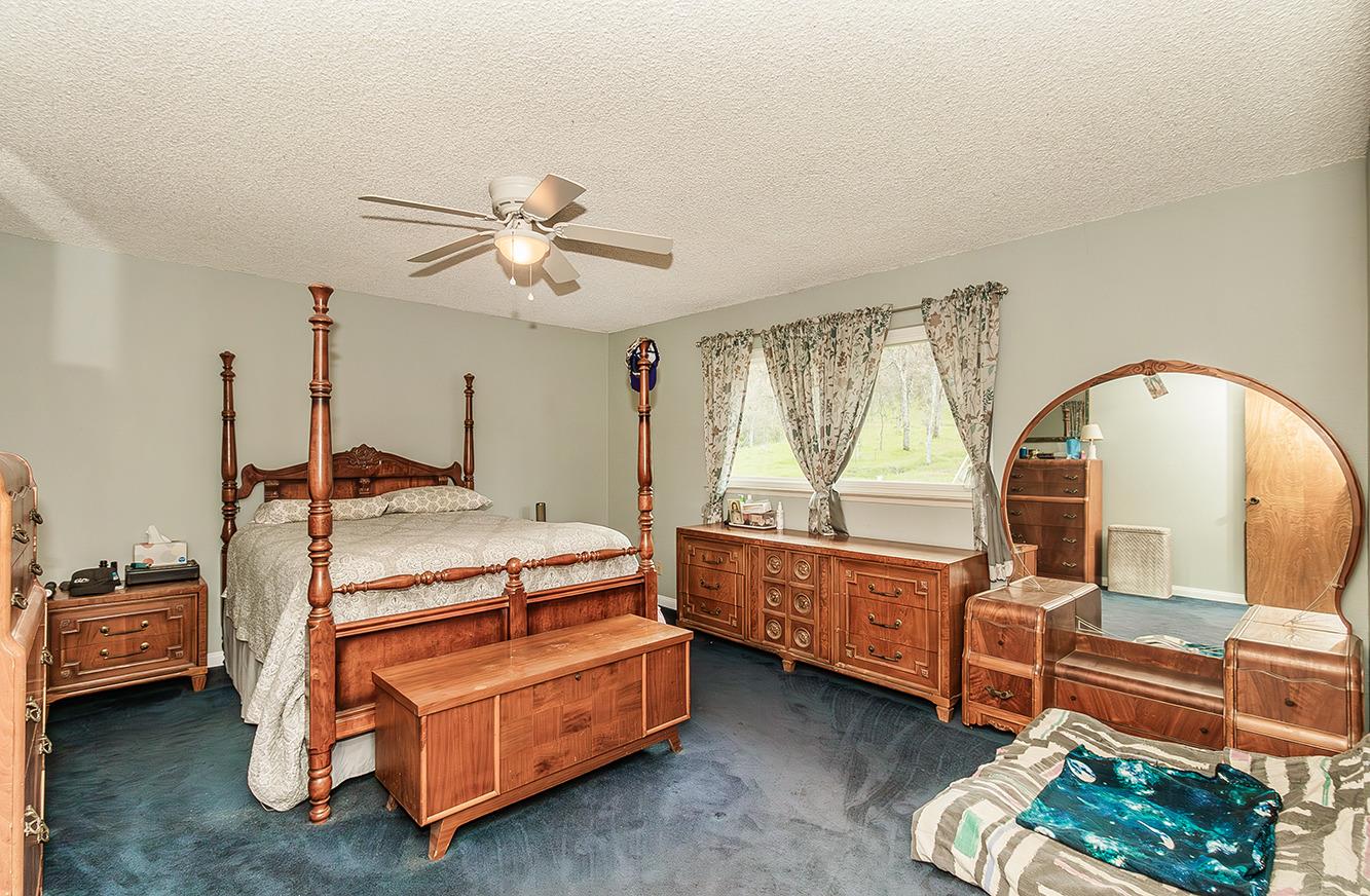 29979 Post Oak Road Tollhouse, CA 93667 - Photo 22 of 42 a bed room with a bed and a chandelier