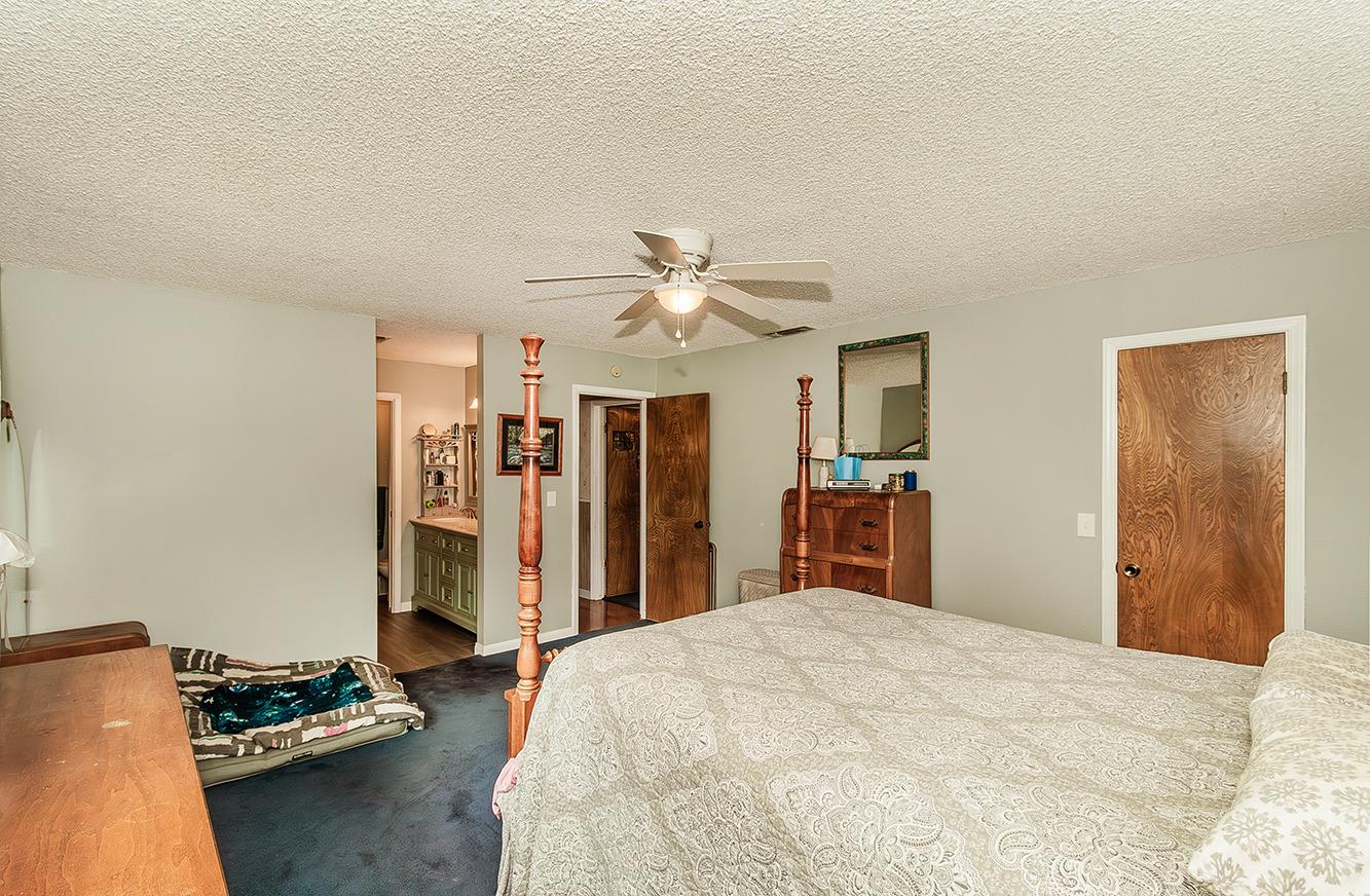 29979 Post Oak Road Tollhouse, CA 93667 - Photo 23 of 42 a bed room with a bed and a chandelier