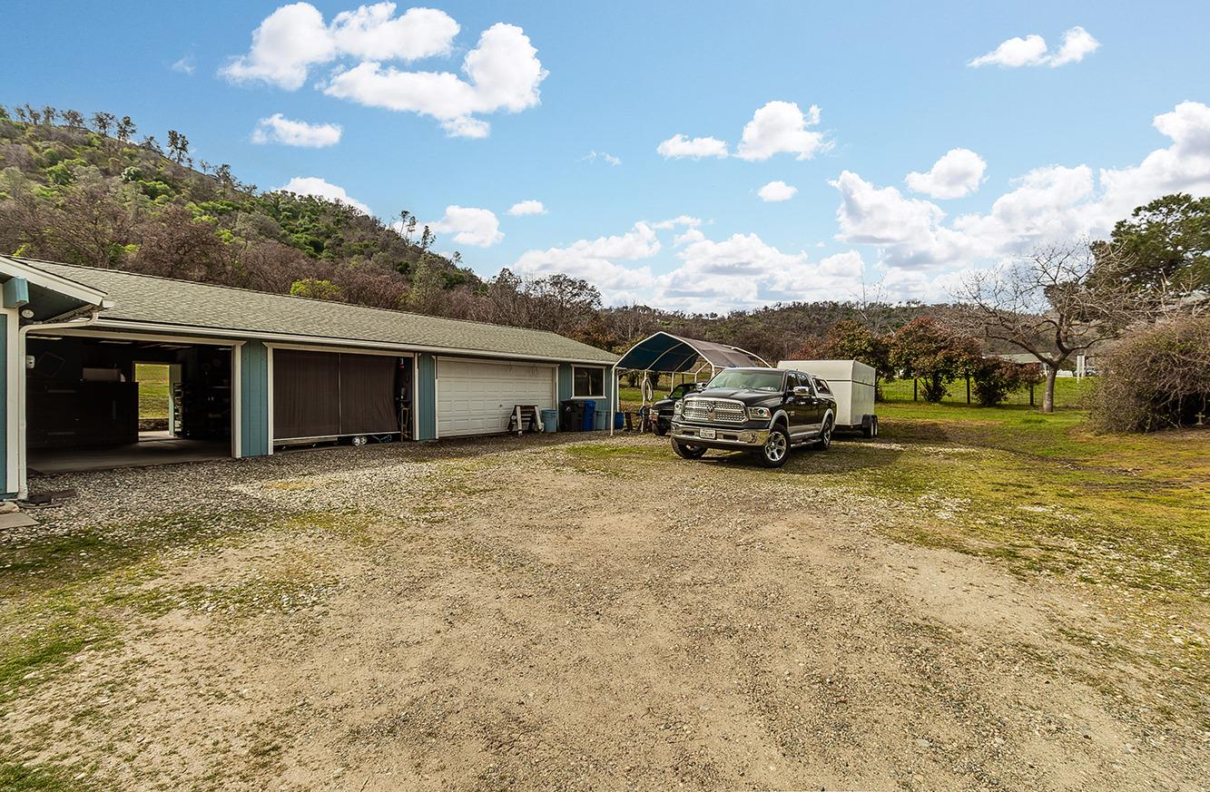 29979 Post Oak Road Tollhouse, CA 93667 - Photo 42 of 42 a front view of a house with a garden and mountain view