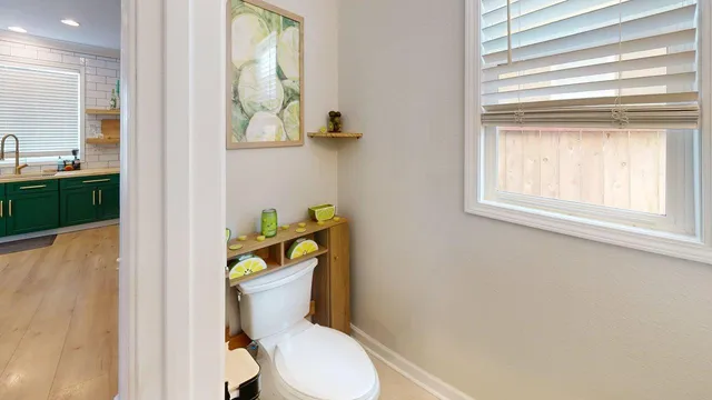 a white toilet sitting next to a bathroom sink