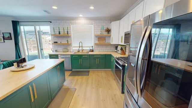 a kitchen with lots of counter top space and stainless steel appliances