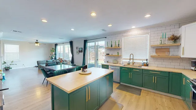 a kitchen with sink and cabinets