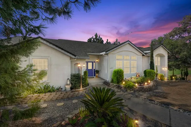 a front view of a house with garden