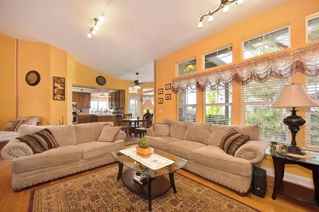 a kitchen with stainless steel appliances kitchen island granite countertop a refrigerator and microwave