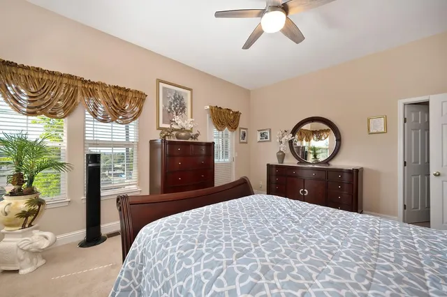 an aerial view of a house with a garden and lake view