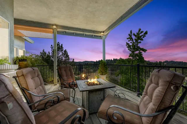 a view of a house with a street and trees