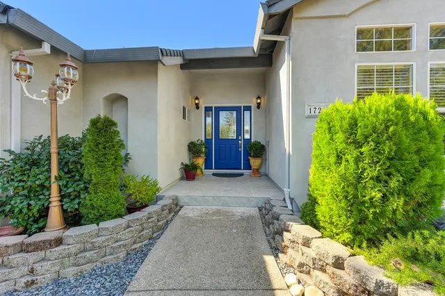 a dining room with furniture a rug and a floor to ceiling window