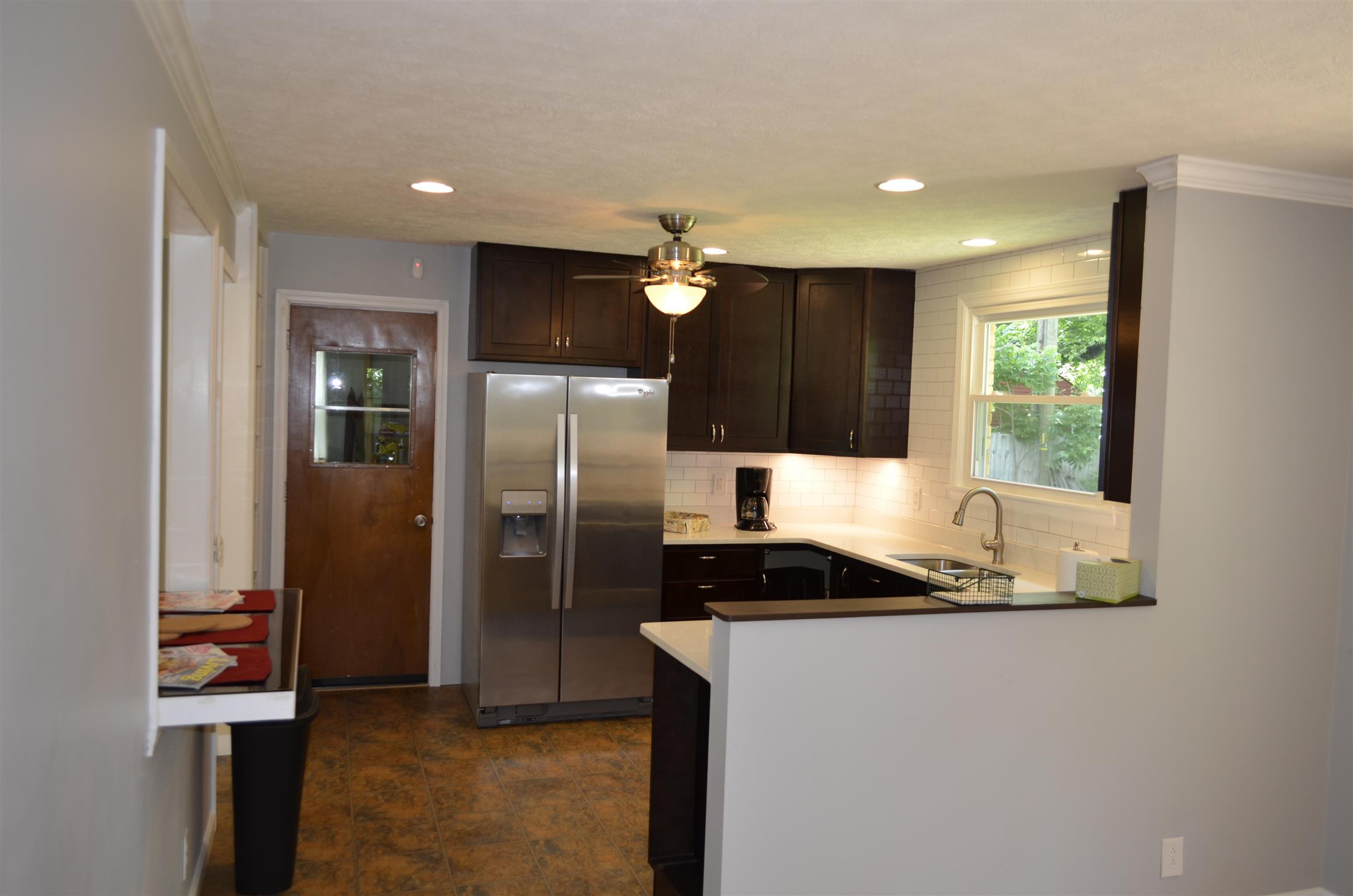 312 Burch Road Clarksville, TN 37042 - Photo 11 of 22 a kitchen with granite countertop a refrigerator and a stove top oven