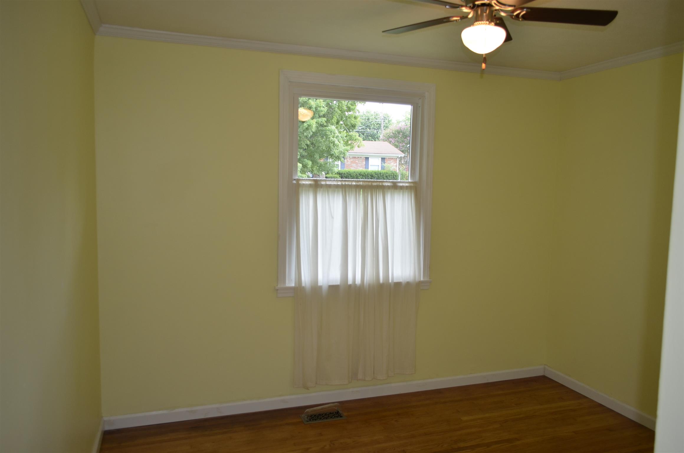 312 Burch Road Clarksville, TN 37042 - Photo 18 of 22 an empty room with wooden floor fan and windows