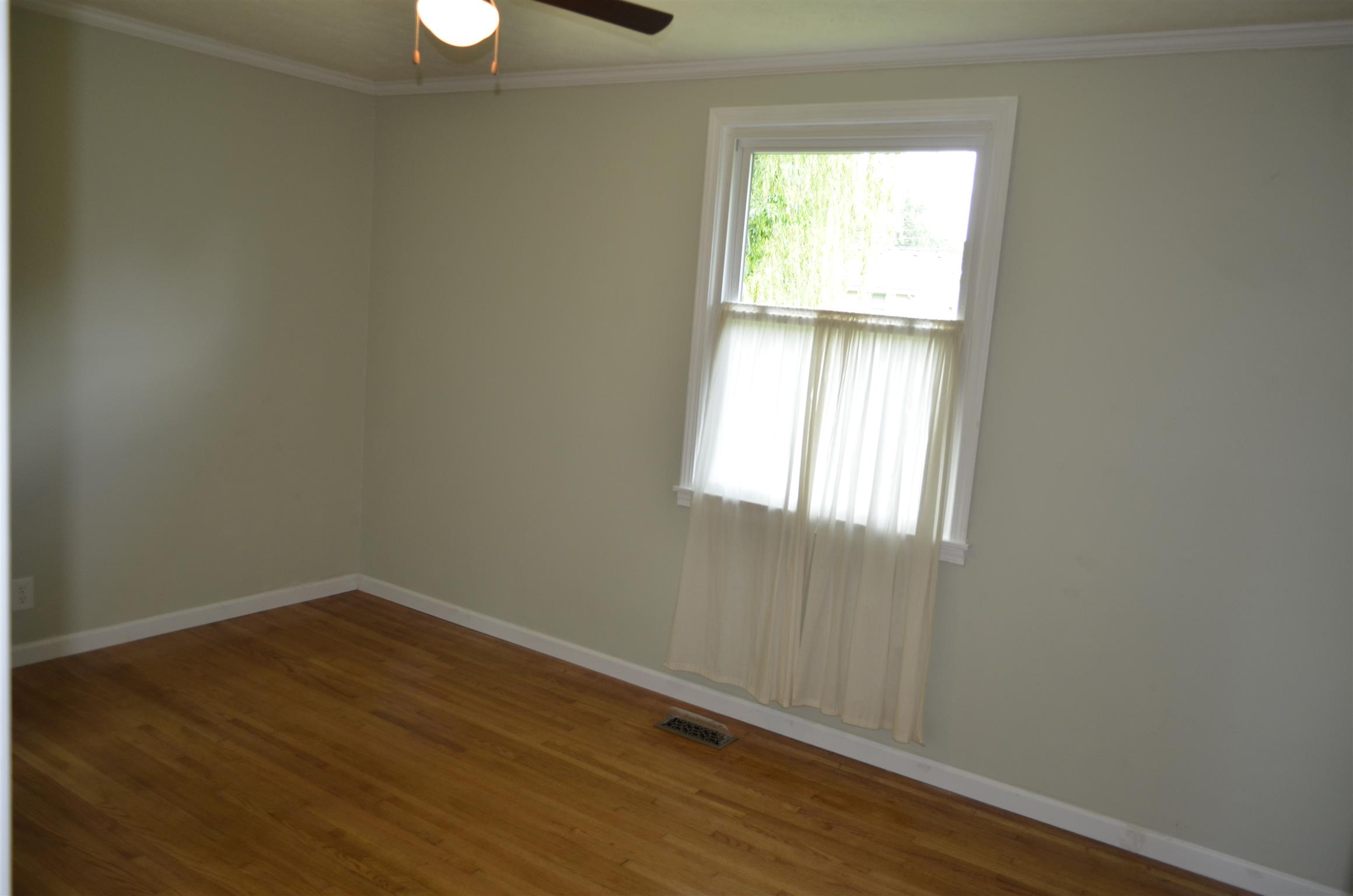 312 Burch Road Clarksville, TN 37042 - Photo 19 of 22 an empty room with wooden floor and windows