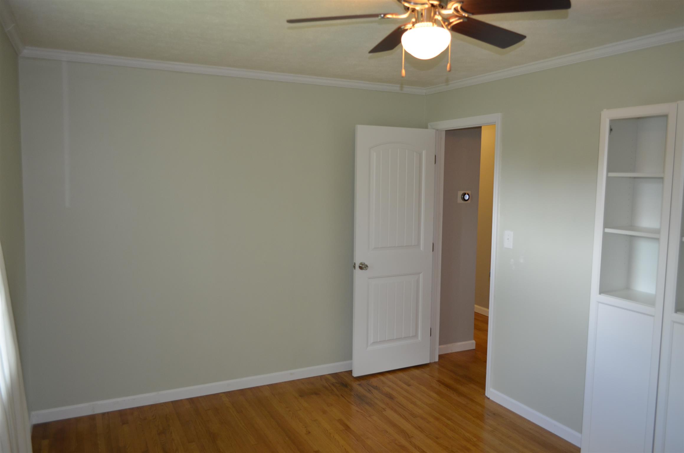 312 Burch Road Clarksville, TN 37042 - Photo 21 of 22 a view of an empty room with wooden floor and a window
