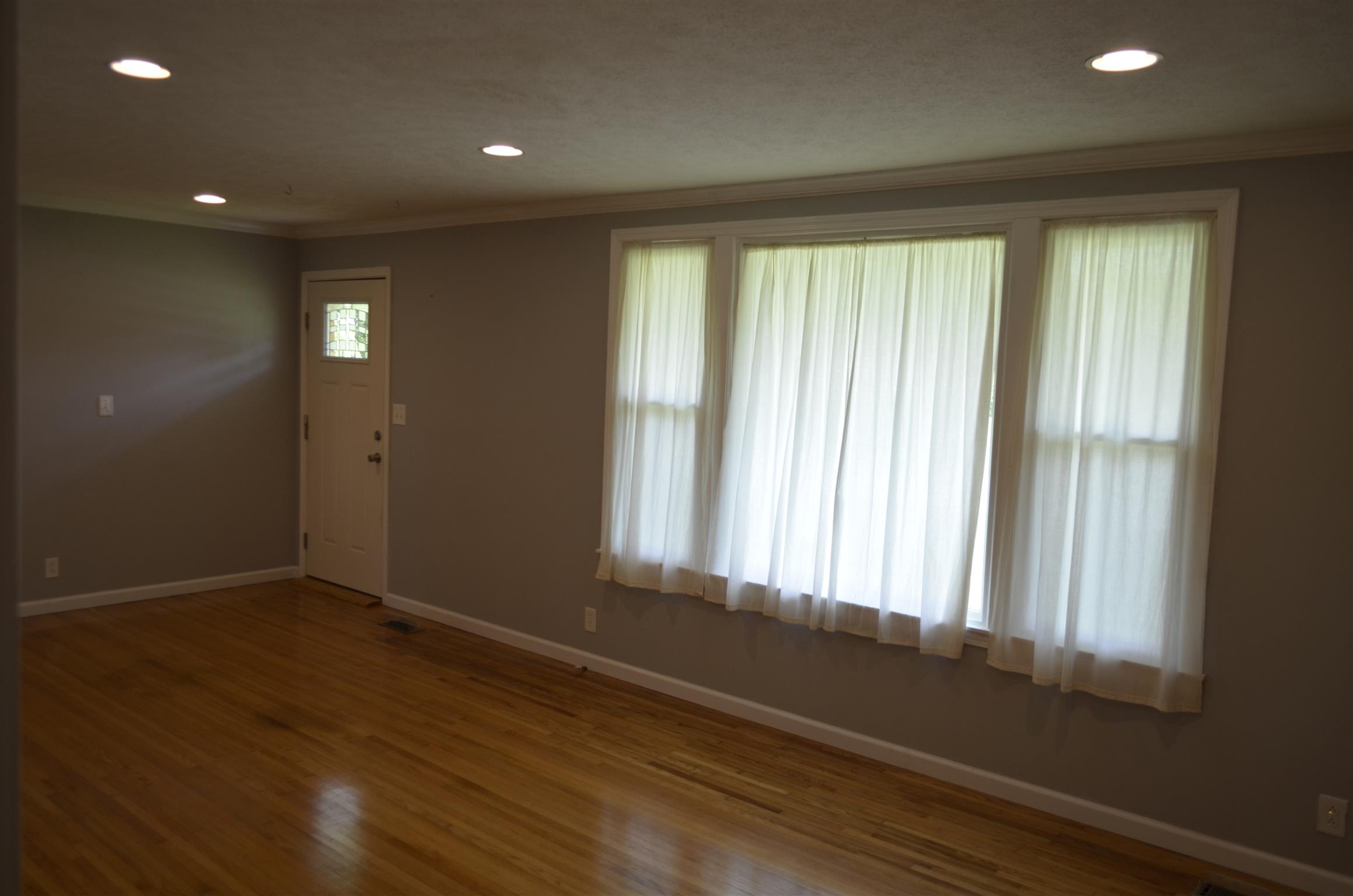 312 Burch Road Clarksville, TN 37042 - Photo 4 of 22 a view of an empty room with wooden floor and a window