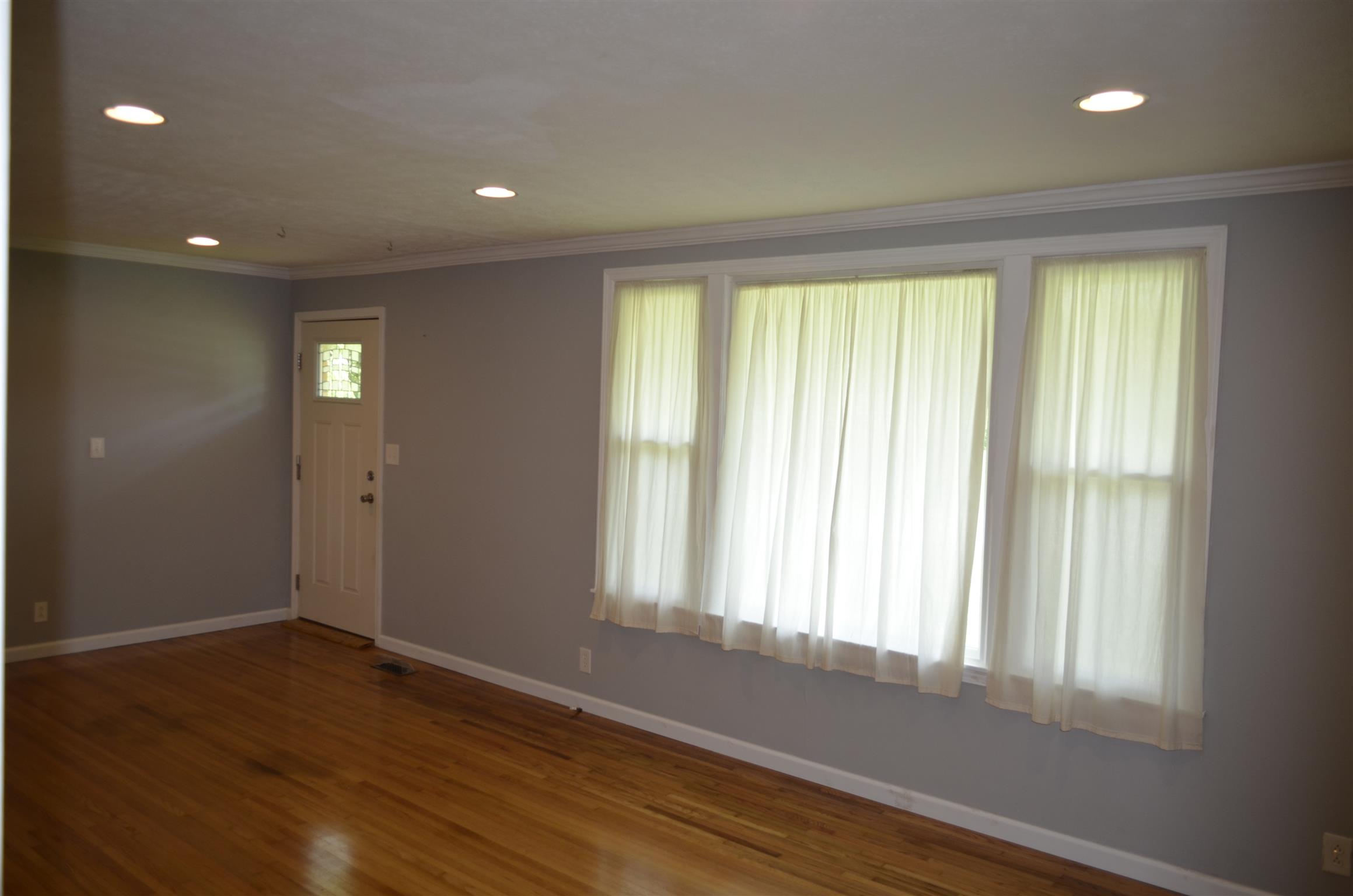 312 Burch Road Clarksville, TN 37042 - Photo 5 of 22 a view of an empty room with wooden floor and a window