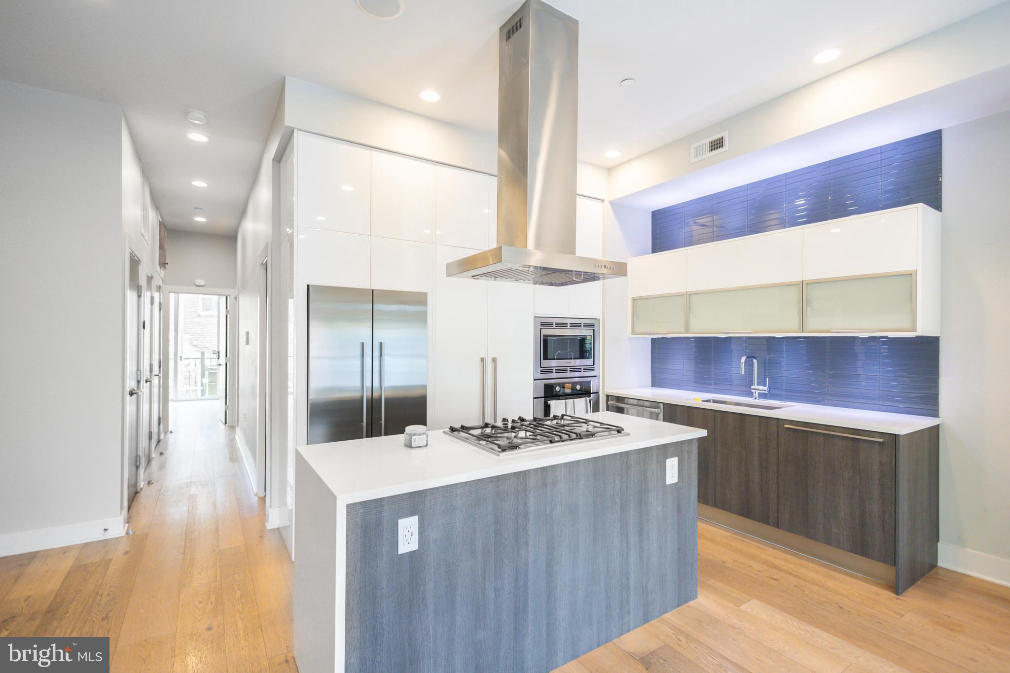 1476 Harvard Street Northwest, Unit C Washington, DC 20009 - Photo 11 of 20 a kitchen with a sink a stove a refrigerator and a cabinets
