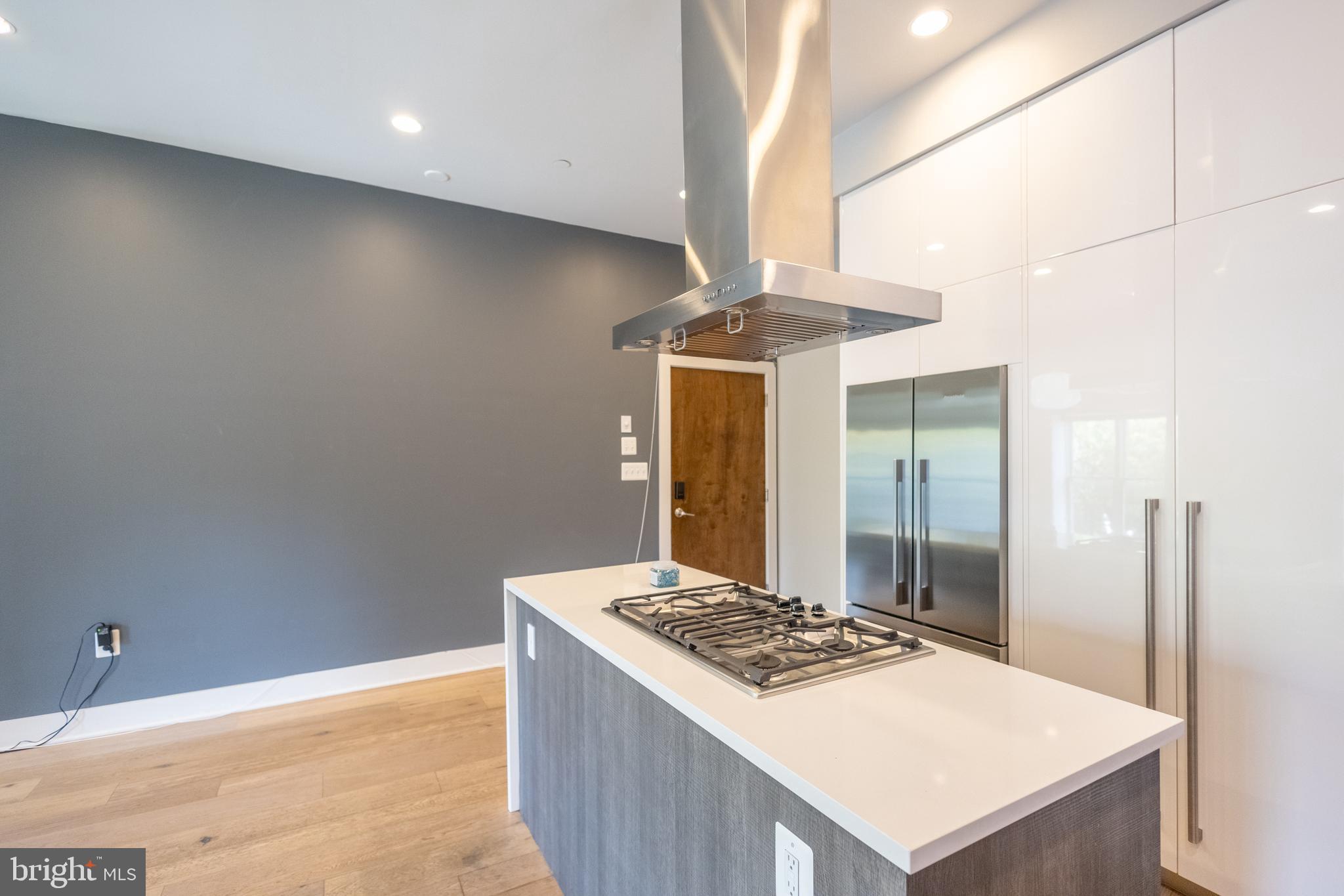 1476 Harvard Street Northwest, Unit C Washington, DC 20009 - Photo 13 of 20 a kitchen with a stove and a refrigerator