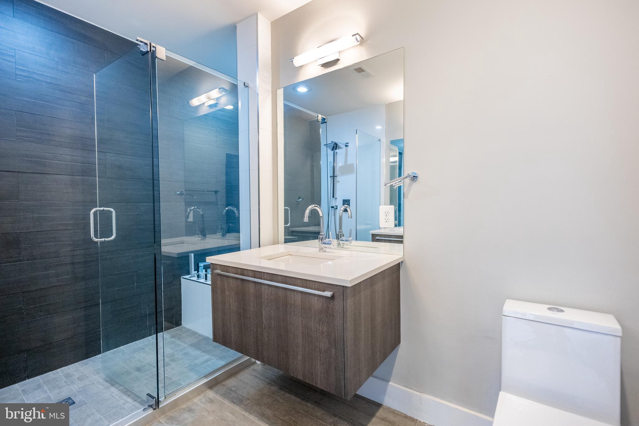 1476 Harvard Street Northwest, Unit C Washington, DC 20009 - Photo 16 of 20 a bathroom with a sink mirror and shower