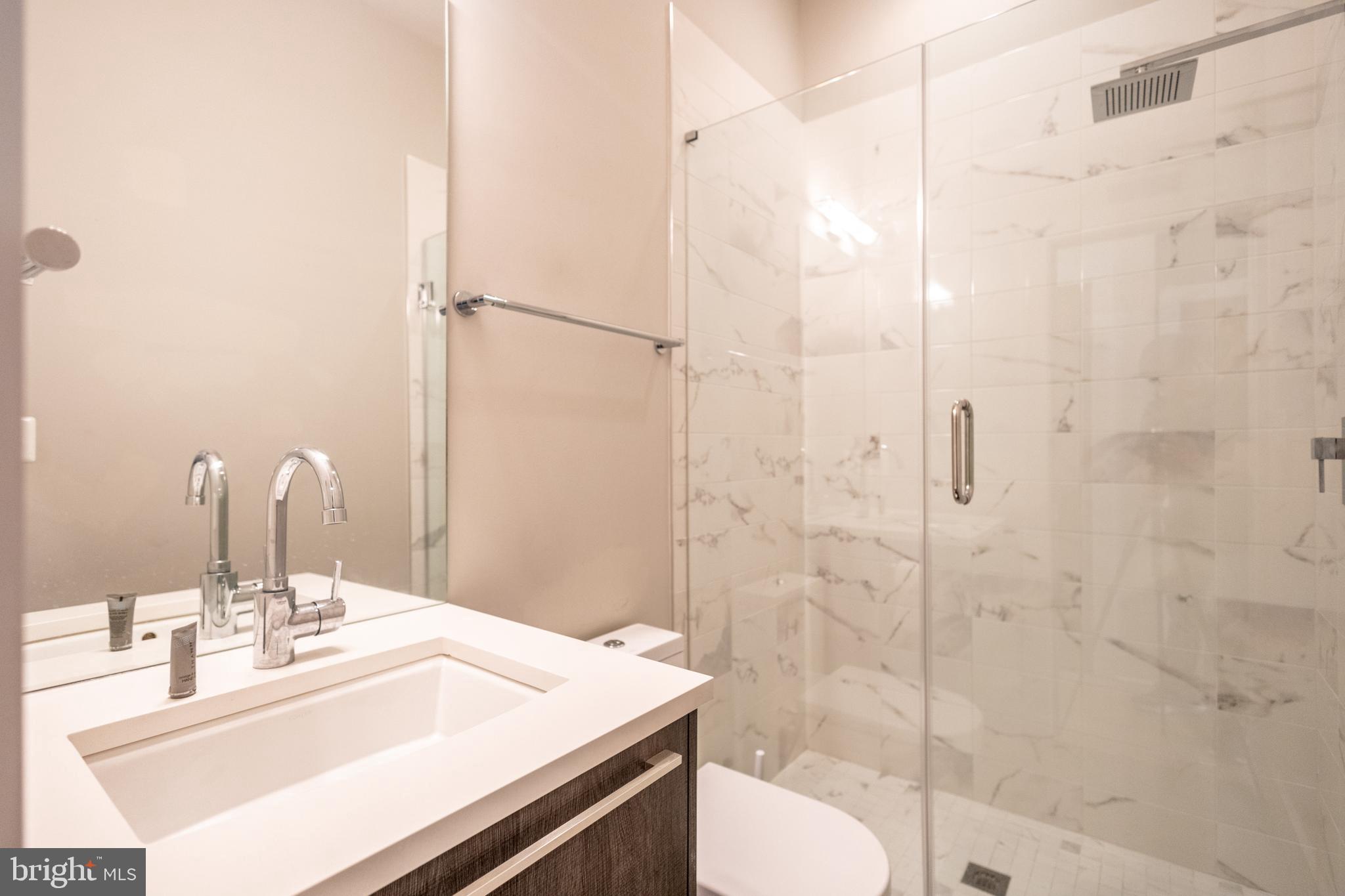 1476 Harvard Street Northwest, Unit C Washington, DC 20009 - Photo 17 of 20 a bathroom with a sink and a mirror