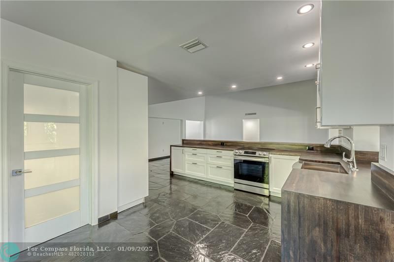 5709 Bamboo Circle Tamarac, FL 33319 - Photo 14 of 47 a kitchen with a stove a sink and a refrigerator
