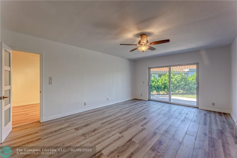 5709 Bamboo Circle Tamarac, FL 33319 - Photo 21 of 47 a view of empty room with wooden floor and fan