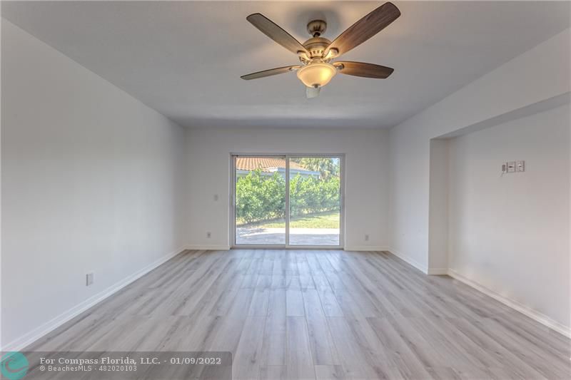 5709 Bamboo Circle Tamarac, FL 33319 - Photo 22 of 47 an empty room with wooden floor and windows