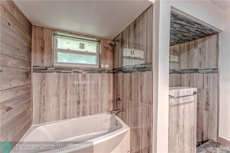 5709 Bamboo Circle Tamarac, FL 33319 - Photo 27 of 47 a bathroom with bathtub and a shower