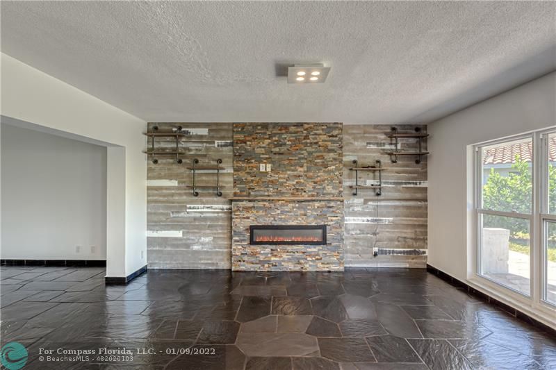 5709 Bamboo Circle Tamarac, FL 33319 - Photo 8 of 47 a view of empty room with fireplace and wooden floor