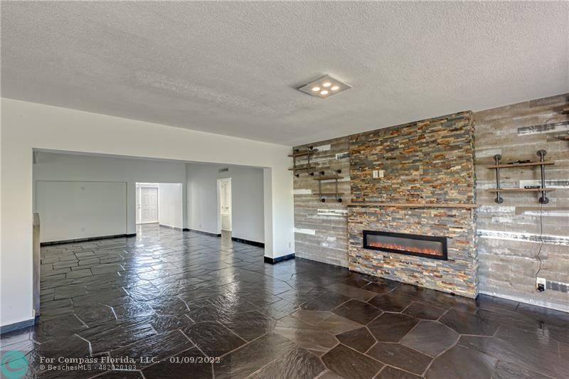 5709 Bamboo Circle Tamarac, FL 33319 - Photo 9 of 47 a view of an empty room with wooden floor and a fireplace