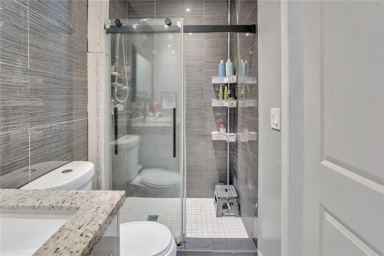 1360 Northwest 77th Street Miami, FL 33147 - Photo 23 of 41 a bathroom with a granite countertop sink toilet and shower