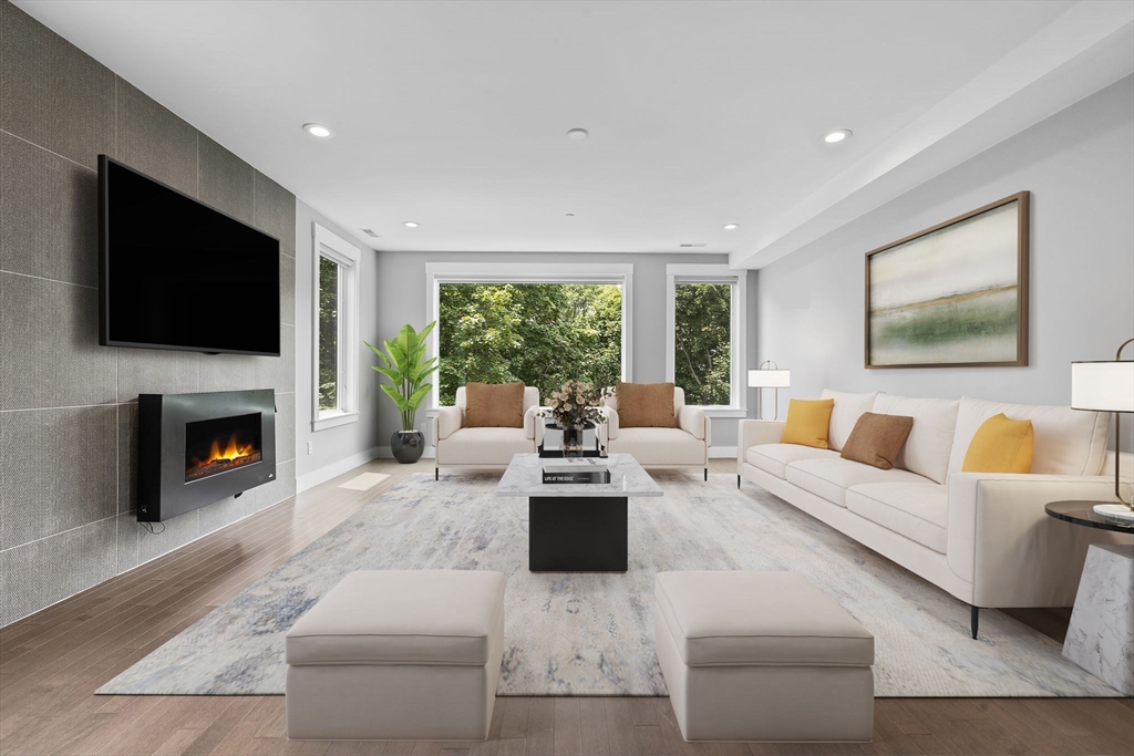 202 Rawson Road, Unit PH 3 Brookline, MA 02445 - Photo 1 of 17 a living room with furniture fireplace and a flat screen tv