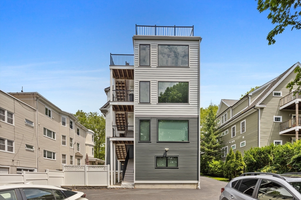 202 Rawson Road, Unit PH 3 Brookline, MA 02445 - Photo 17 of 17 a front view of a building with a garden