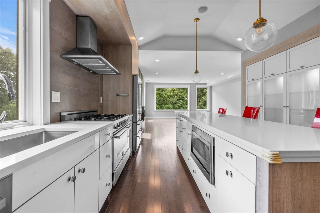 202 Rawson Road, Unit PH 3 Brookline, MA 02445 - Photo 2 of 17 a large kitchen with stainless steel appliances lots of counter space and wooden floor