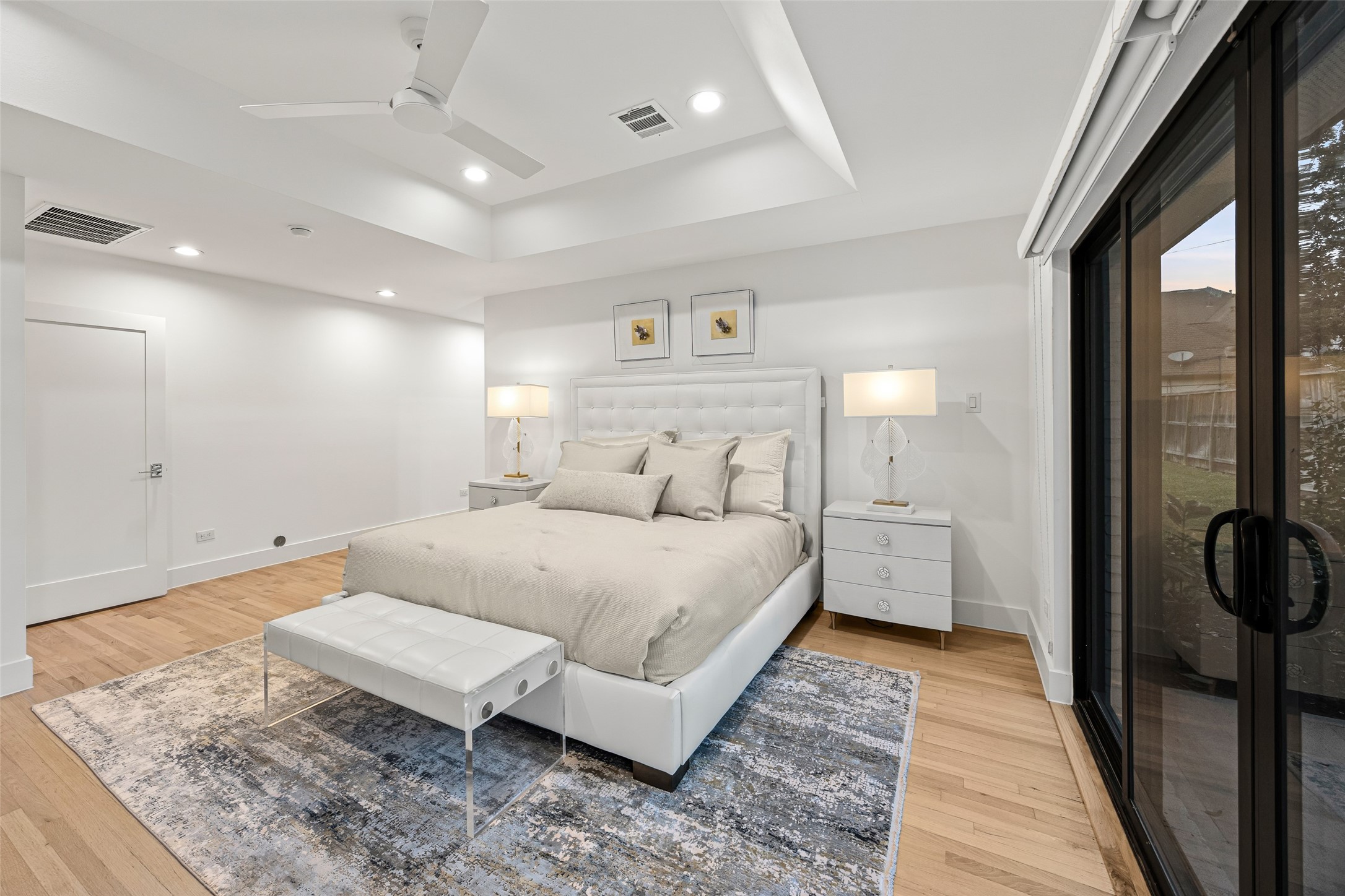 5658 Del Monte Drive Houston, TX 77056 - Photo 12 of 35 a spacious bedroom with a bed and wooden floor