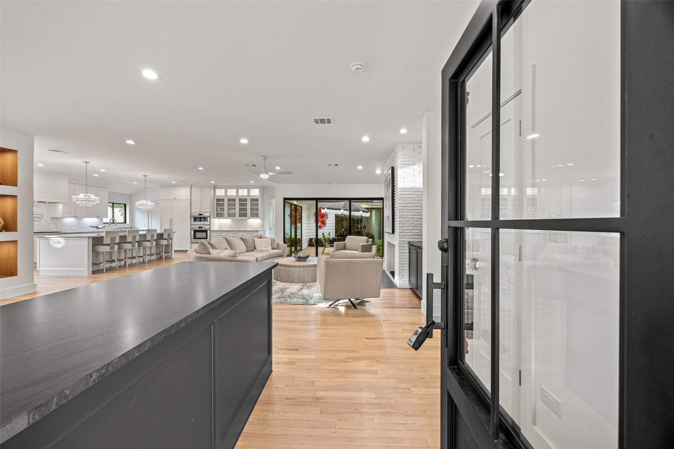 5658 Del Monte Drive Houston, TX 77056 - Photo 2 of 35 a view of a kitchen with kitchen island a counter top space a sink a refrigerator and a view of living room