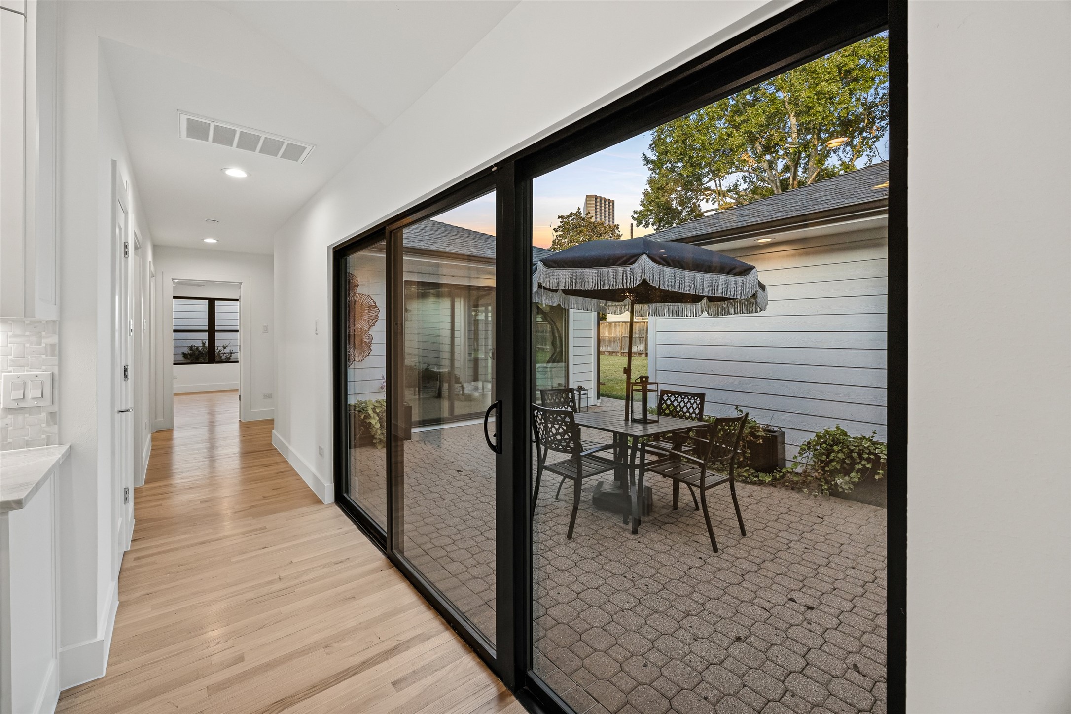 5658 Del Monte Drive Houston, TX 77056 - Photo 23 of 35 a view of a hallway with wooden floor and a floor to ceiling window