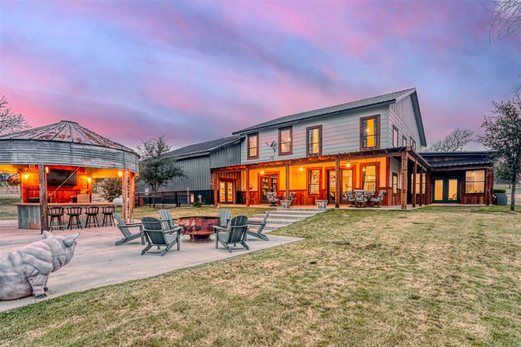 a backyard of a house with table and chairs