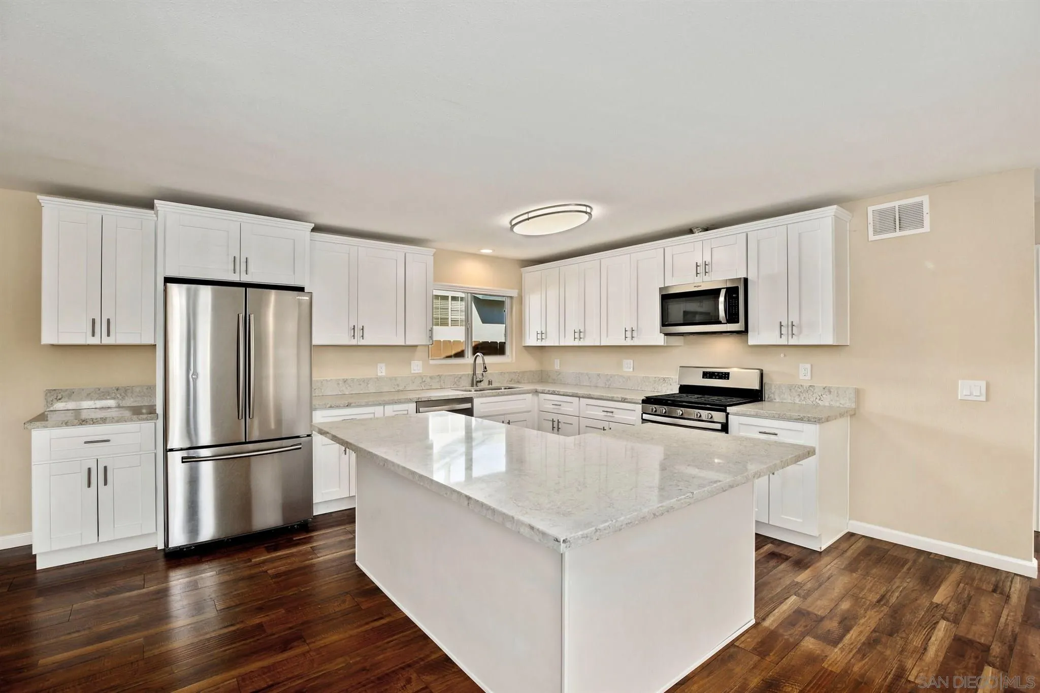 13441 Tobiasson Road Poway, CA 92064 - Photo 3 of 29 a kitchen with stainless steel appliances a refrigerator stove microwave and sink