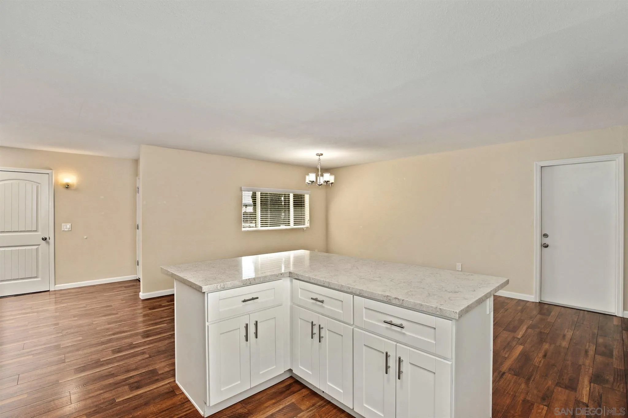 13441 Tobiasson Road Poway, CA 92064 - Photo 6 of 29 a hallway with white cabinets and wooden floor