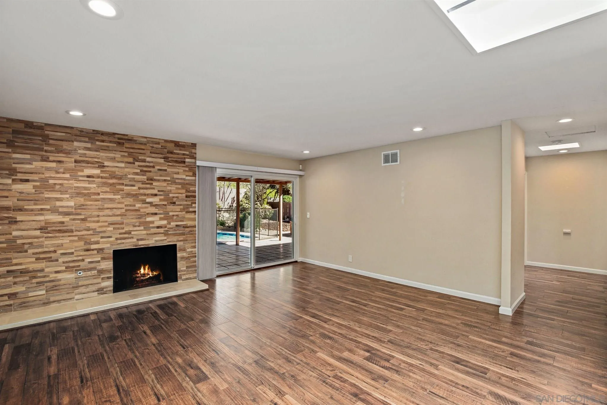 13441 Tobiasson Road Poway, CA 92064 - Photo 9 of 29 an empty room with wooden floor and fireplace
