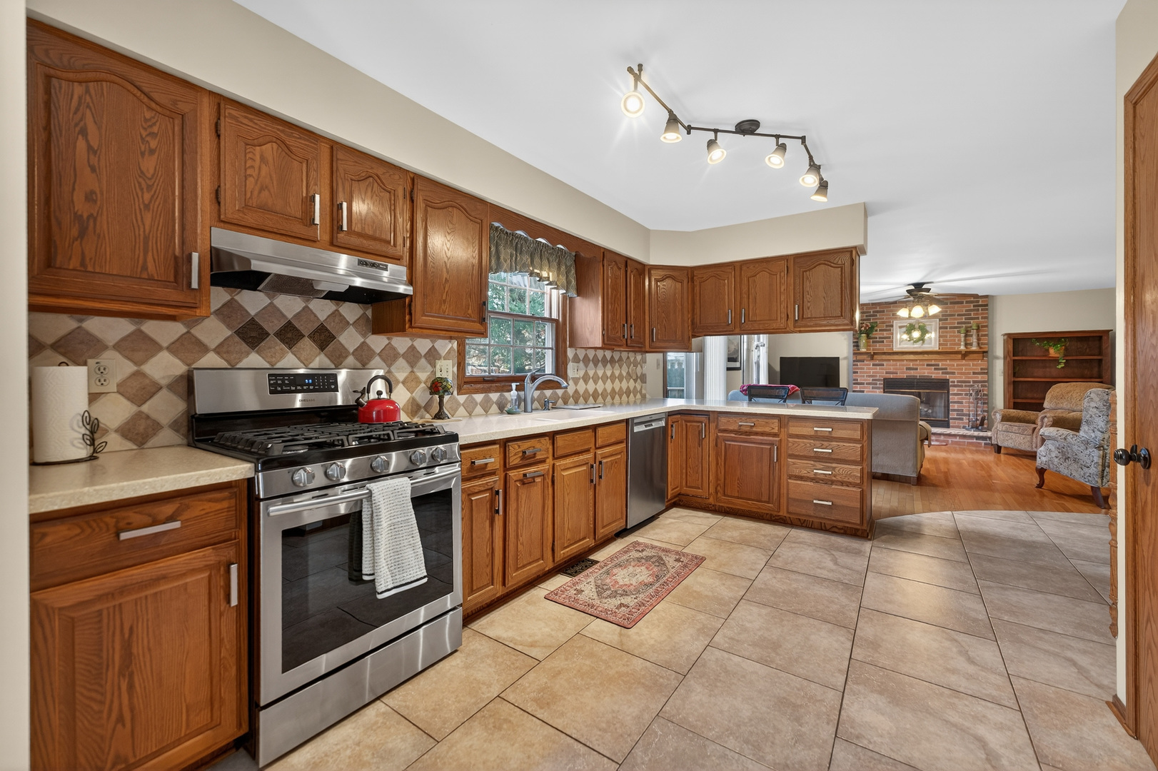 1524 John Street Sycamore, IL 60178 - Photo 12 of 52 a kitchen with stainless steel appliances granite countertop a stove sink and cabinets