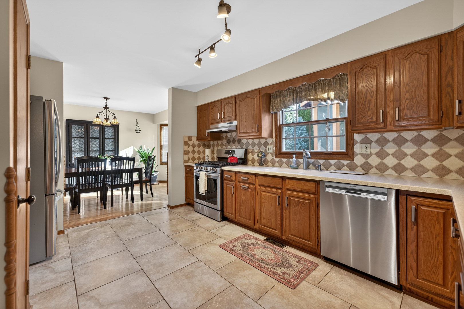 1524 John Street Sycamore, IL 60178 - Photo 2 of 52 a kitchen with stainless steel appliances granite countertop a stove top oven a sink a dining table and chairs