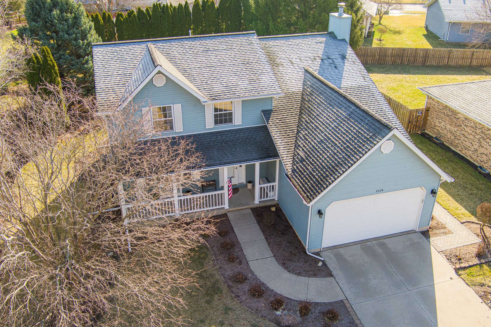 1524 John Street Sycamore, IL 60178 - Photo 39 of 52 an aerial view of a house with swimming pool and large trees