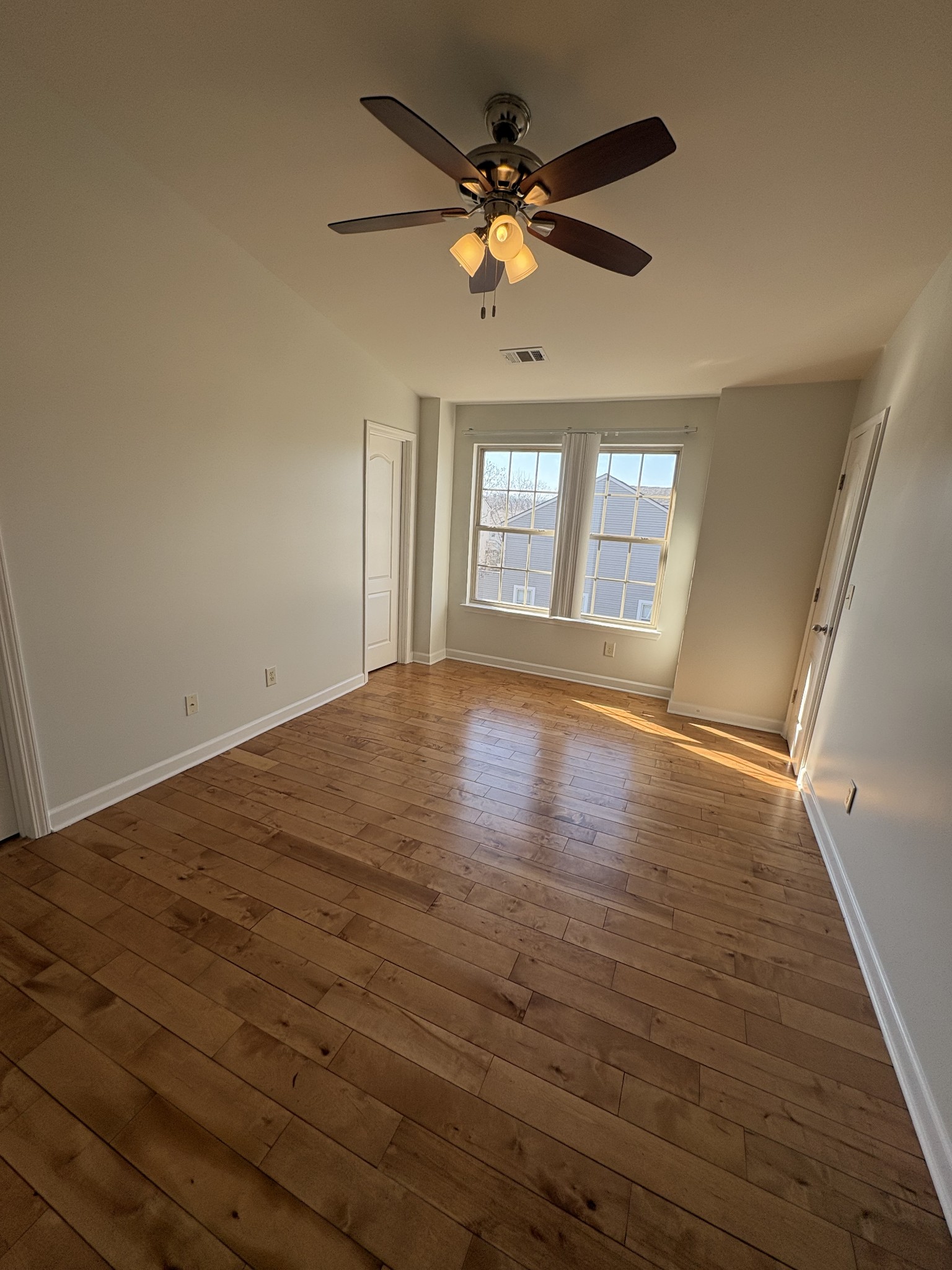 735 Tulip Grove Road, Unit 303 Hermitage, TN 37076 - Photo 9 of 16 wooden floor in an empty room with a window