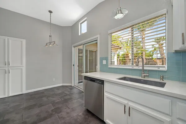 a kitchen with granite countertop a sink and a window