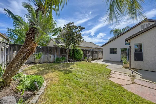 a front view of house with yard and trees