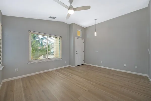 wooden floor in an empty room with a window
