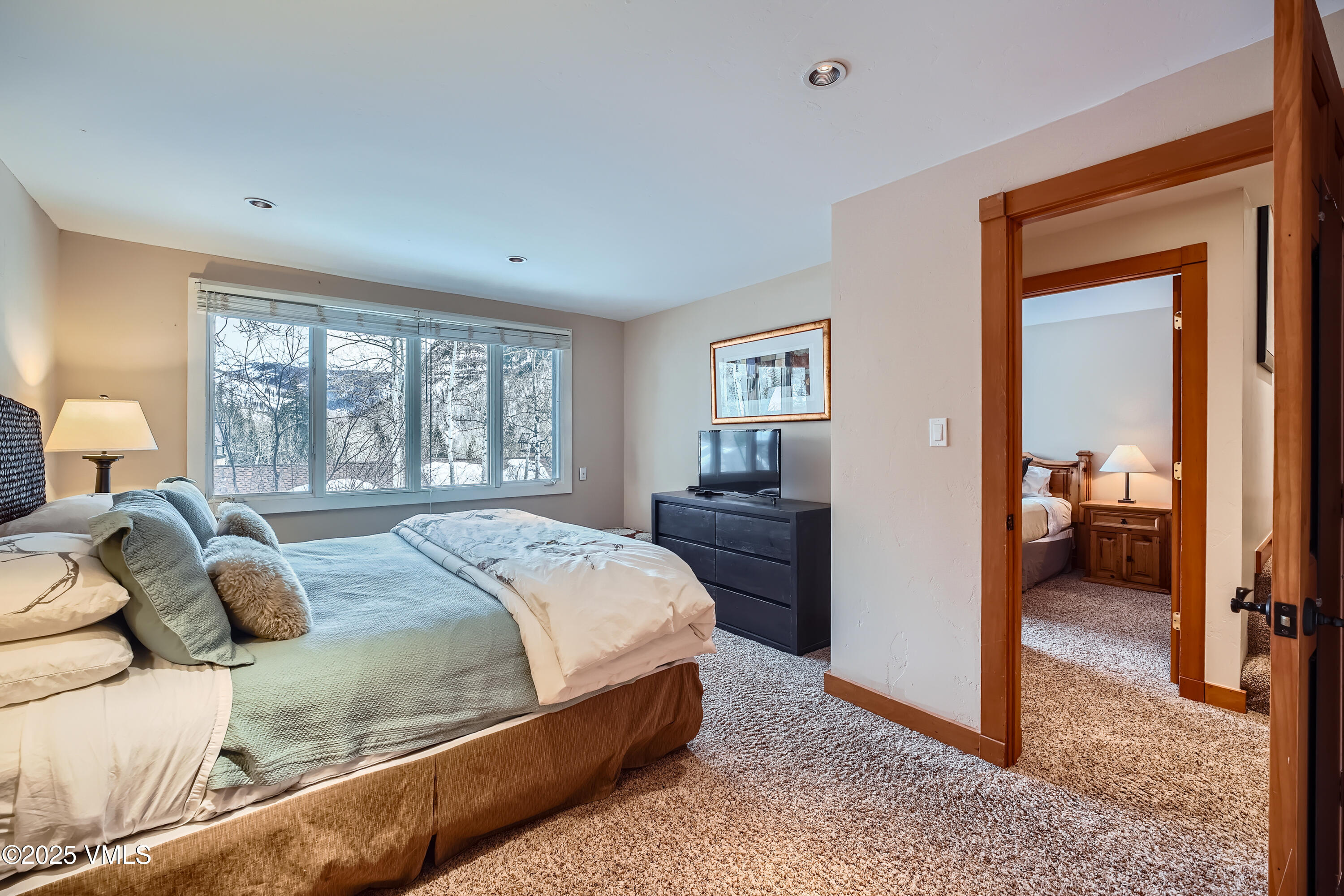 2875 Manns Ranch Road, Unit J2 Vail, CO 81657 - Photo 19 of 25 a bedroom with a bed and large windows