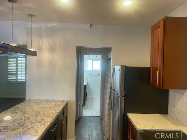 a kitchen with a refrigerator and a sink