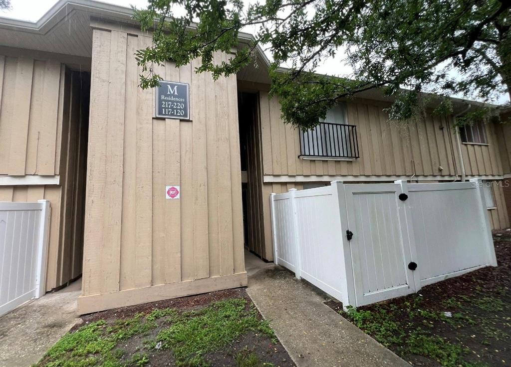 a view of a house with a wooden fence