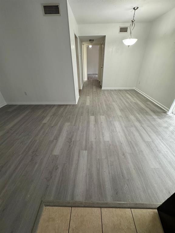 507 Northwest 39th Road, Unit 220 Gainesville, FL 32607 - Photo 15 of 21 an empty room with wooden floor and windows