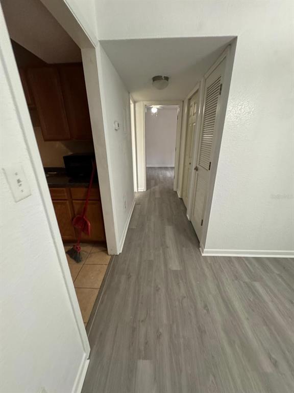 507 Northwest 39th Road, Unit 220 Gainesville, FL 32607 - Photo 16 of 21 a view of a hallway with wooden floor and staircase